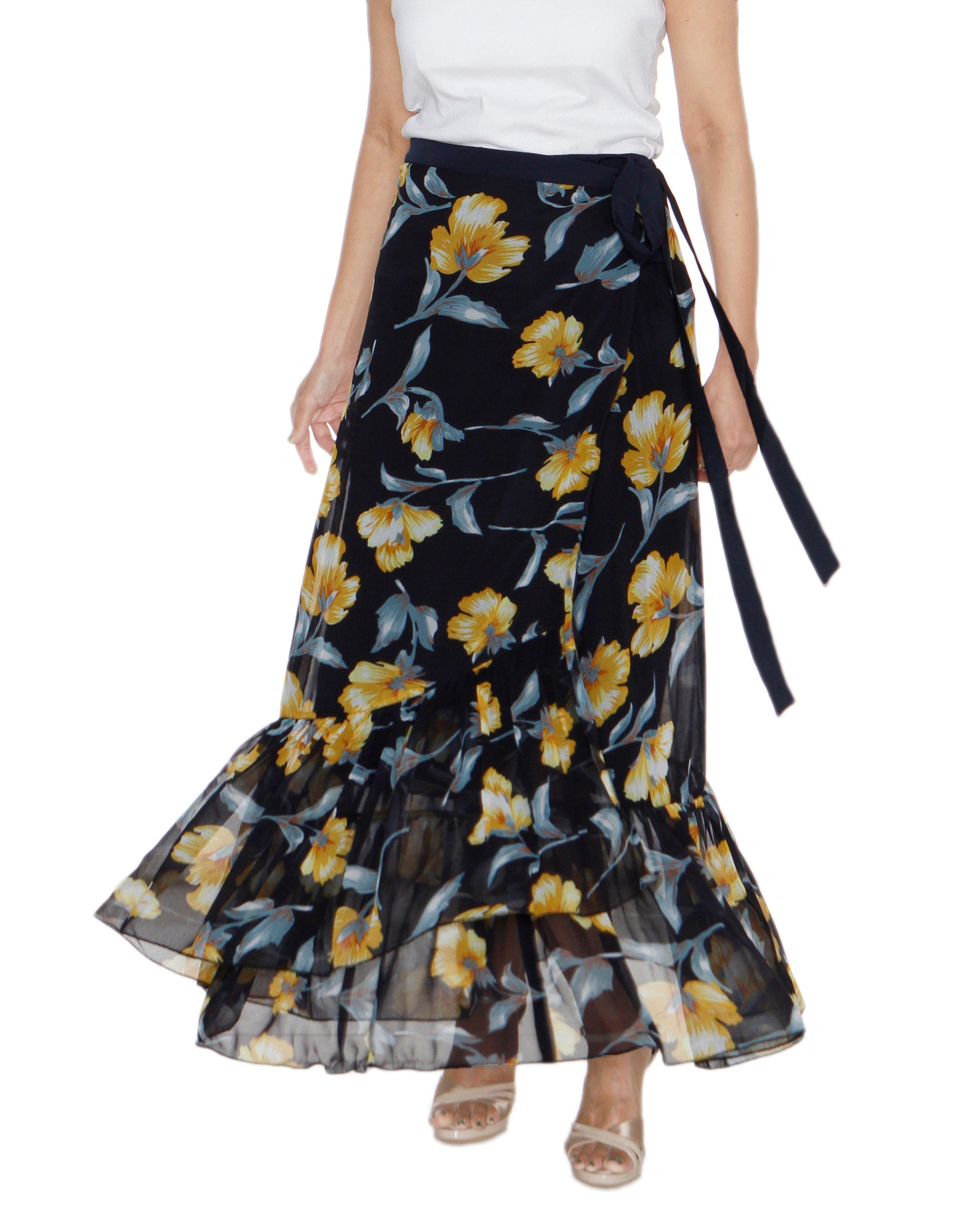 Woman wearing a yellow floral print on dark blue free size wrap skirt with ruffles at the hem