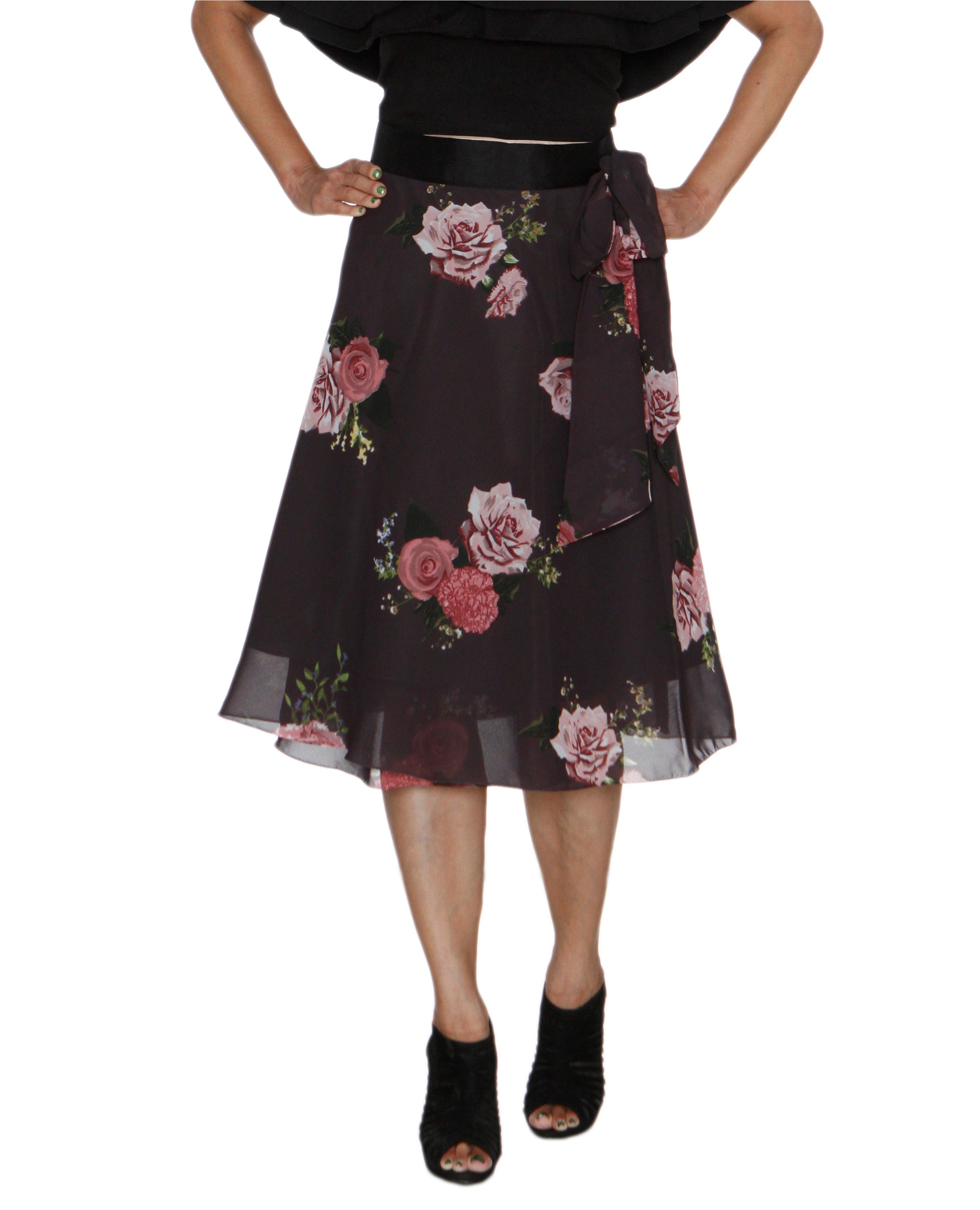Woman wearing free size wrap skirt with floral pattern, rose print, on gray synthetic fabric with a top WA000210