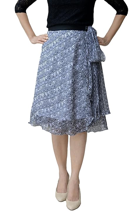 Person wearing a black and white chiffon printed free size wrap skirt with a black top on a white background WA000091